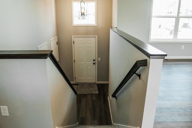 staircase featuring a notable chandelier and hardwood / wood-style floors