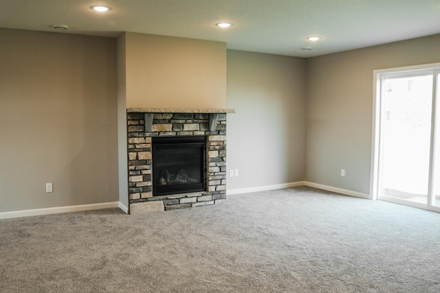 unfurnished living room featuring carpet and a fireplace