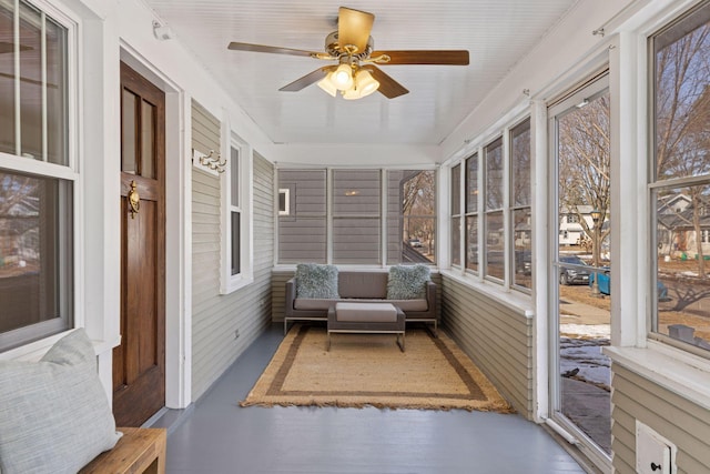 sunroom with a ceiling fan