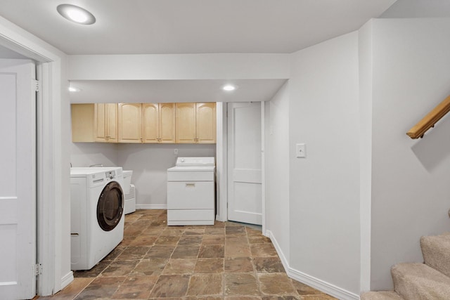 laundry room featuring laundry area, stone finish flooring, baseboards, and washer and clothes dryer