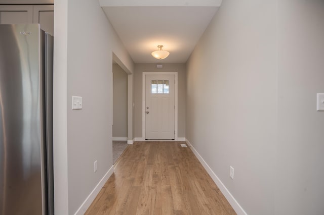 doorway with light wood-type flooring