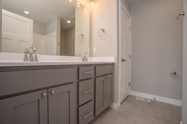 bathroom featuring walk in shower and vanity