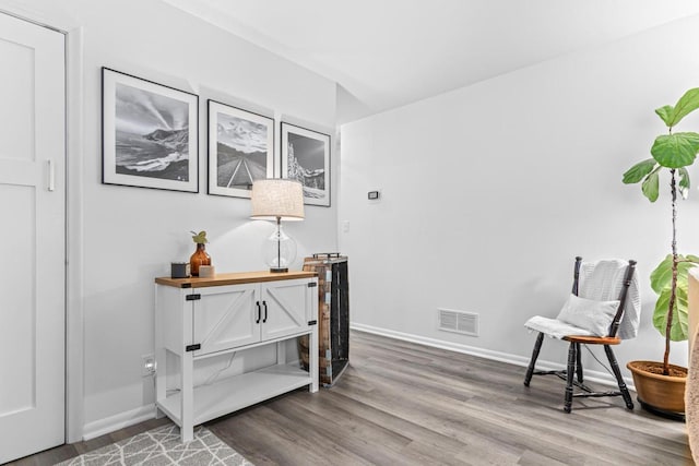 living area with hardwood / wood-style flooring