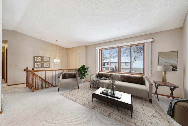 living room with light colored carpet, lofted ceiling, and a textured ceiling