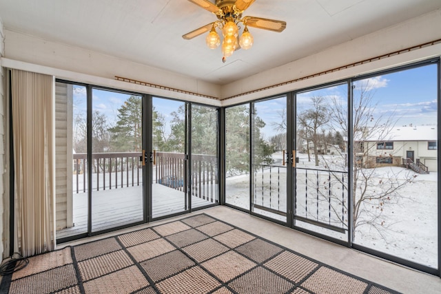 unfurnished sunroom with plenty of natural light and ceiling fan