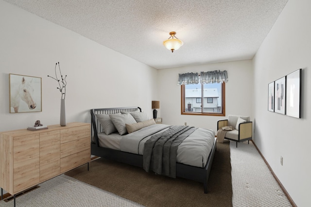 bedroom featuring carpet floors and a textured ceiling