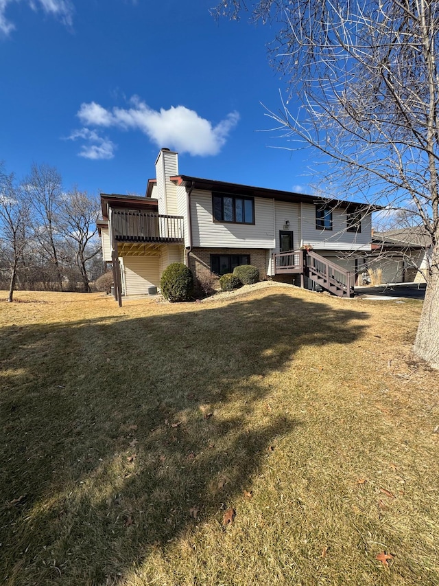 exterior space featuring brick siding, a yard, and a chimney