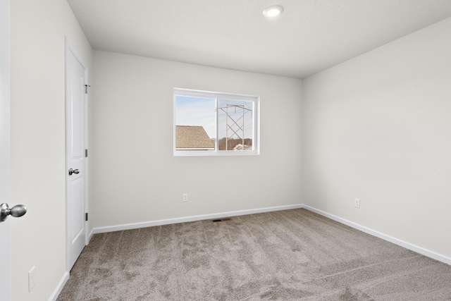 empty room featuring light carpet