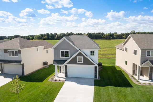 view of front of house featuring central AC unit, a front lawn, and a garage