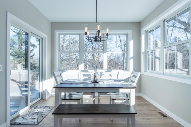 sunroom featuring an inviting chandelier and a wealth of natural light