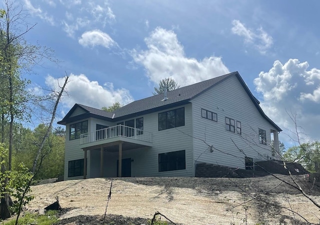 back of property featuring a balcony