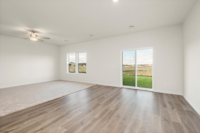 empty room featuring ceiling fan and light wood-type flooring