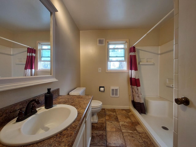 bathroom with toilet, vanity, and a shower with shower curtain