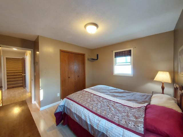 bedroom featuring a closet and light hardwood / wood-style flooring