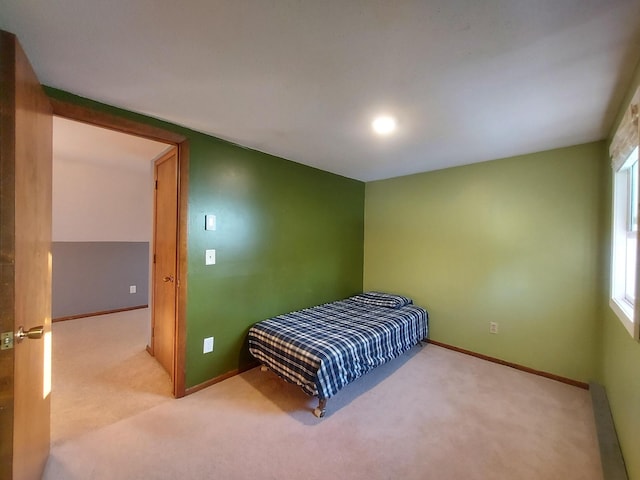 carpeted bedroom with multiple windows