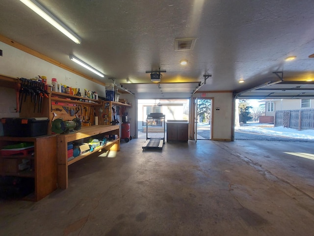 garage featuring a garage door opener and a workshop area