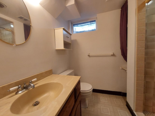 bathroom with toilet, walk in shower, and vanity