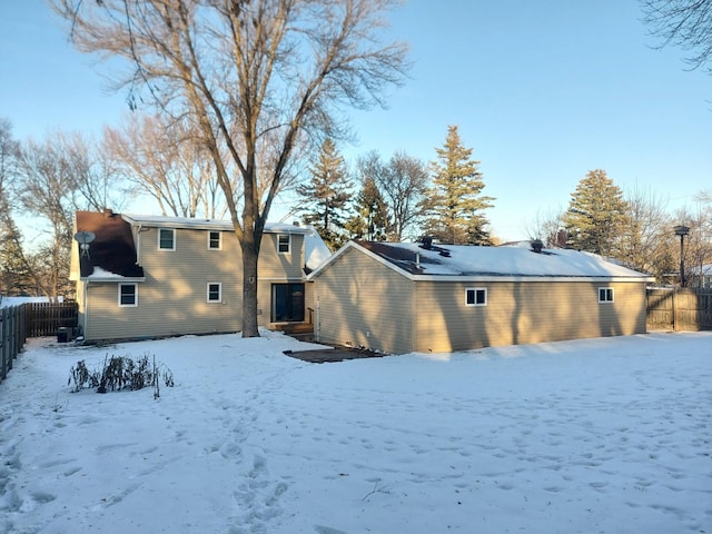 view of snow covered rear of property