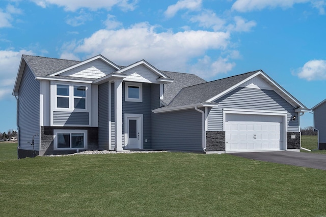 view of front of property featuring a garage and a front yard