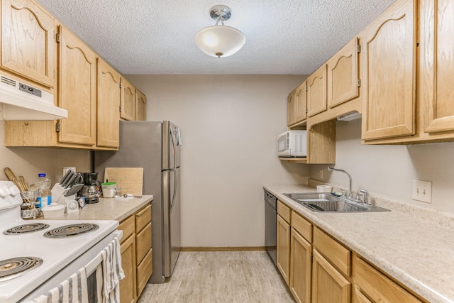 kitchen with sink, white appliances, light hardwood / wood-style floors, a textured ceiling, and light brown cabinetry