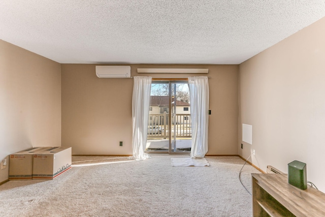 unfurnished room featuring light carpet, a textured ceiling, and a wall unit AC