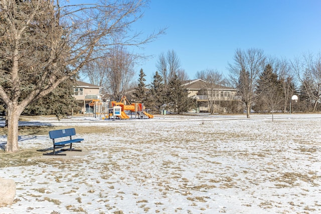 yard layered in snow featuring a playground