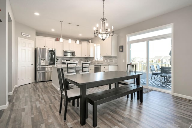 dining room with visible vents, baseboards, dark wood finished floors, an inviting chandelier, and recessed lighting