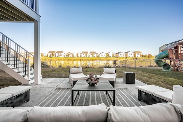 view of patio featuring stairway, a residential view, fence, and an outdoor living space