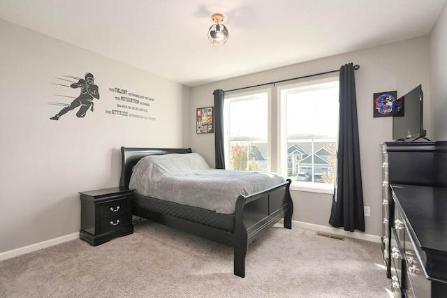 bedroom featuring light carpet, visible vents, and baseboards