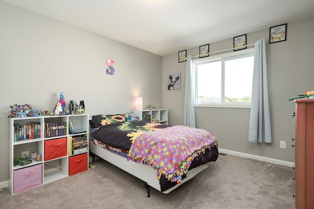 bedroom featuring a textured ceiling, carpet, and baseboards