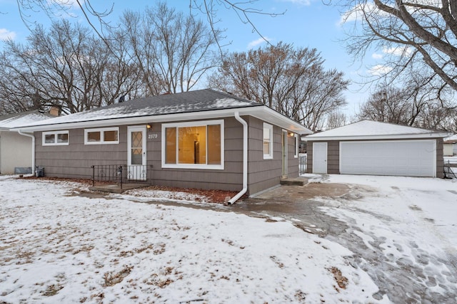 view of front of property with a garage and an outbuilding