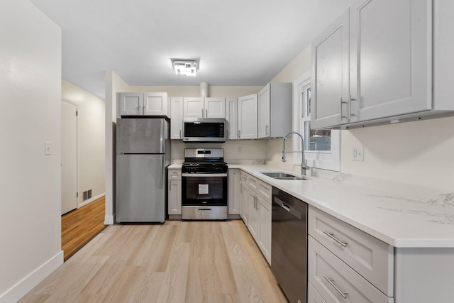 kitchen featuring sink, stainless steel appliances, and light hardwood / wood-style flooring