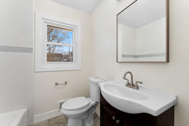 bathroom with toilet, vanity, and a tub to relax in