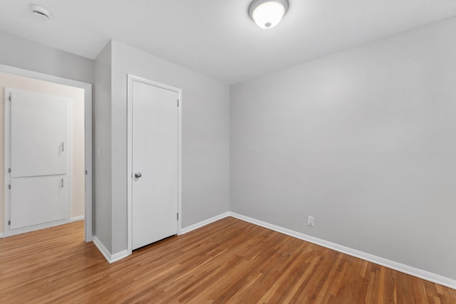 empty room with light hardwood / wood-style floors