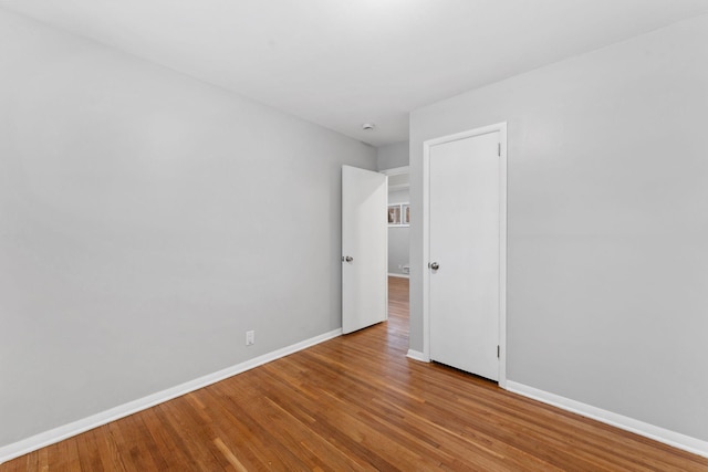 spare room with hardwood / wood-style floors