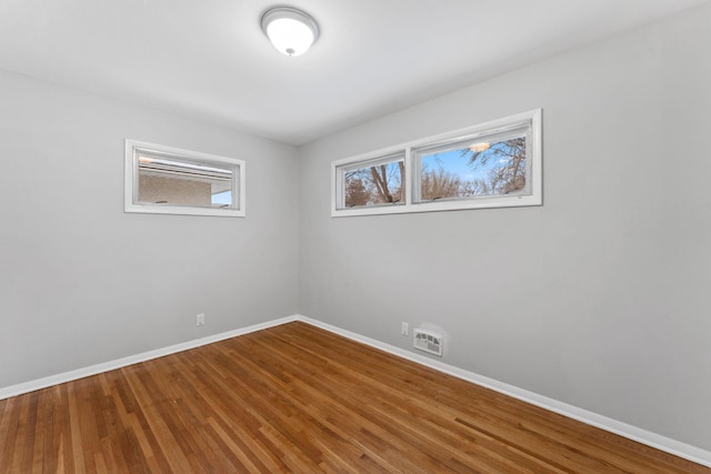 spare room with hardwood / wood-style floors