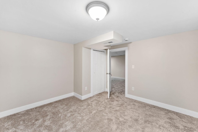 unfurnished bedroom featuring light carpet and a closet