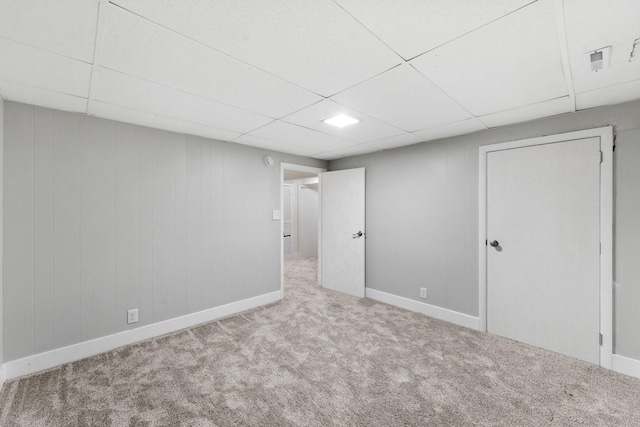 interior space with light carpet and a drop ceiling