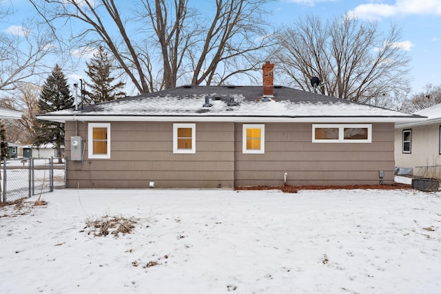 view of snow covered rear of property