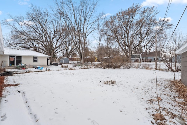 view of yard layered in snow