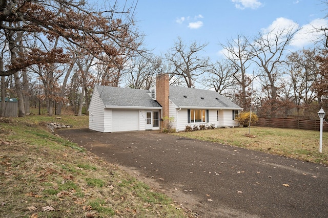 view of front facade with a front lawn and a garage