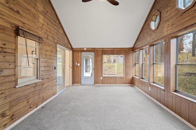 unfurnished sunroom with ceiling fan and vaulted ceiling