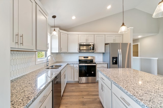 kitchen with stainless steel appliances, white cabinets, pendant lighting, and sink