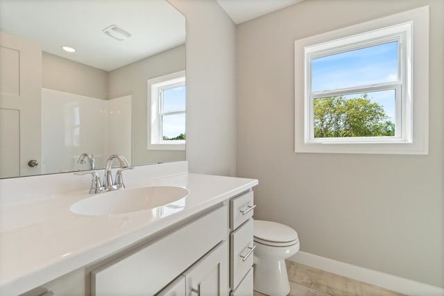 bathroom featuring walk in shower, tile patterned floors, vanity, and toilet