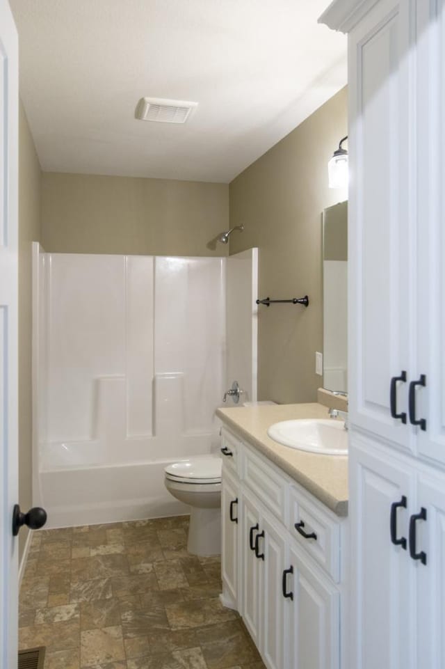 full bathroom featuring toilet, vanity, and tub / shower combination