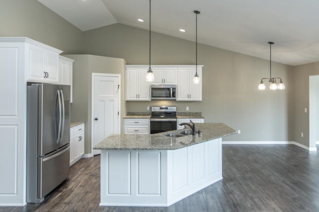 kitchen featuring stainless steel appliances, white cabinets, decorative light fixtures, lofted ceiling, and sink