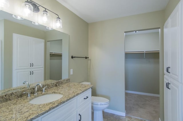 bathroom featuring toilet and vanity