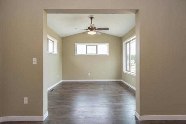 unfurnished room featuring ceiling fan, dark wood-type flooring, vaulted ceiling, and plenty of natural light