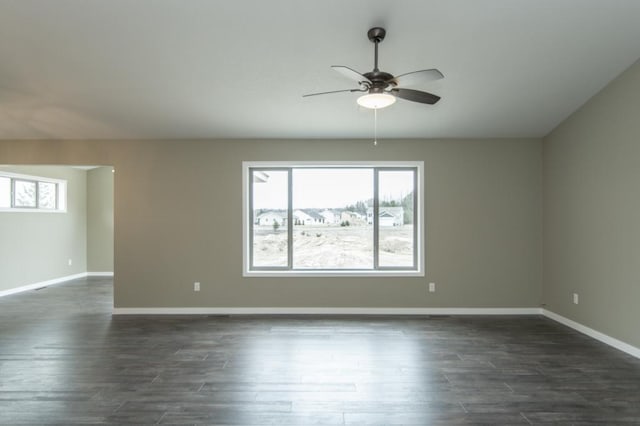 empty room featuring ceiling fan and dark wood-type flooring