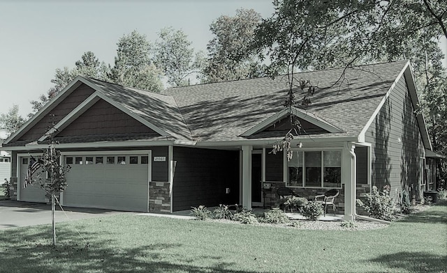 view of front of property with a porch, a front lawn, and a garage